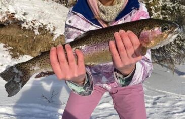 Chelsey holding a rainbow trout